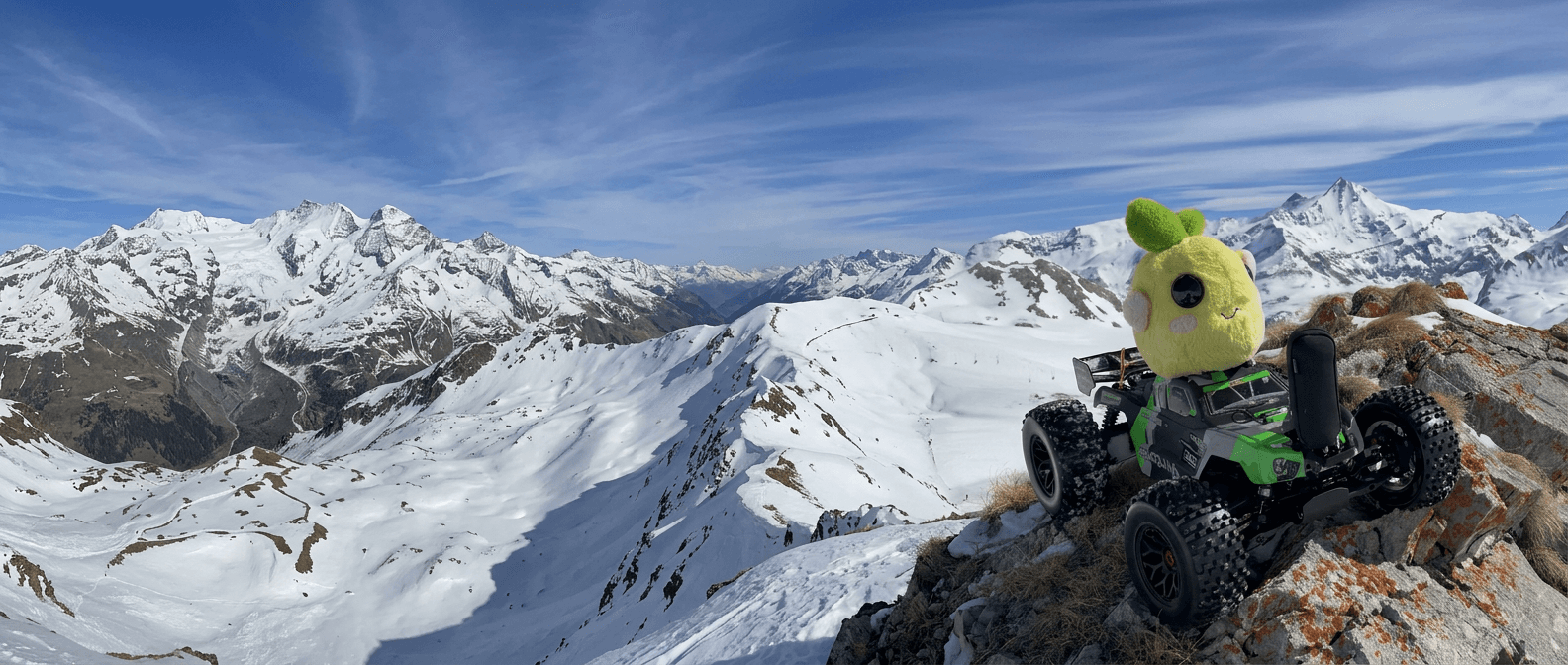 Emy on a snowy mountain summit in her monster truck